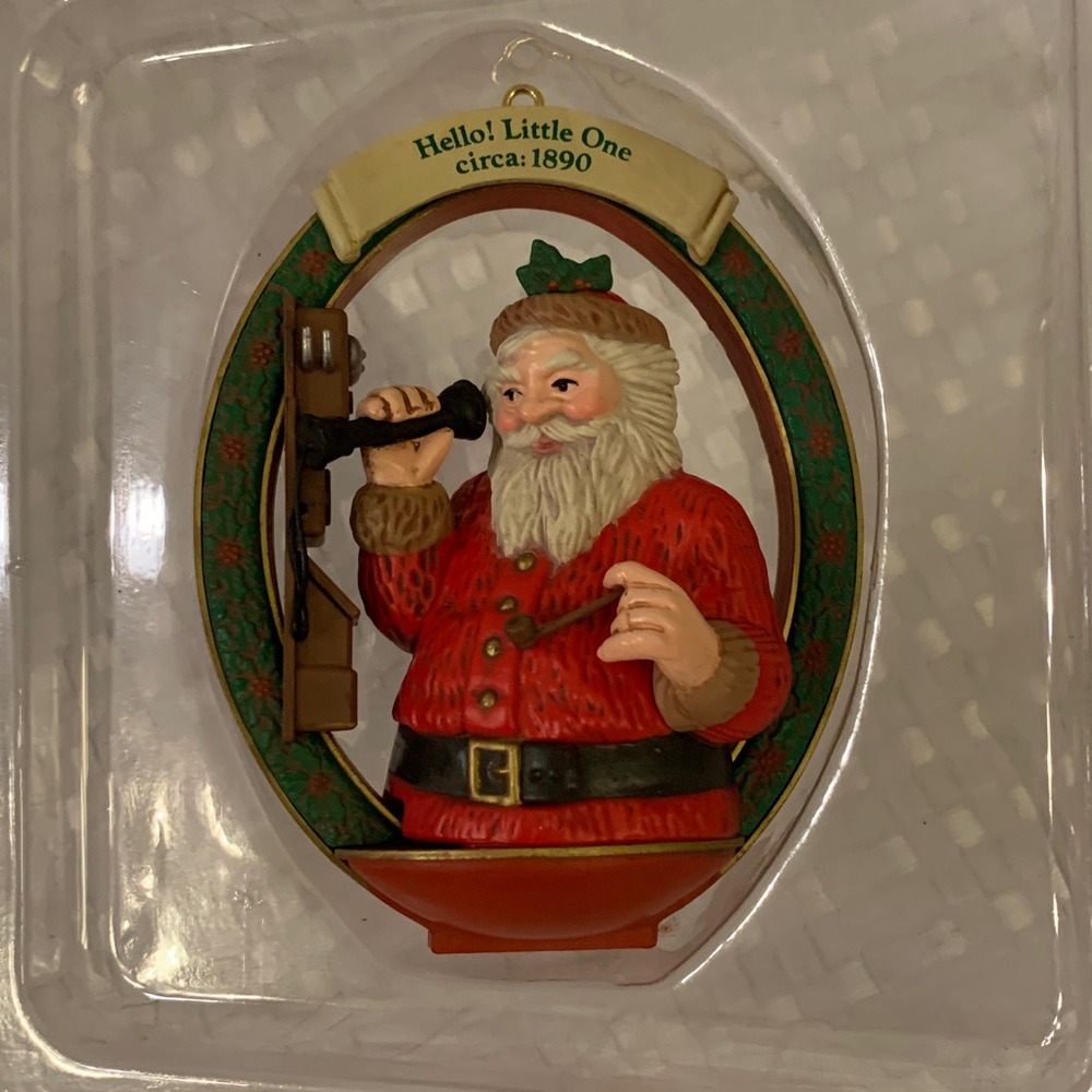 Christmas ornament featuring Santa on the phone saying hello to a child.